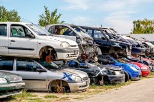 Old cars stacked neatly in a professional Perth car scrap yard, ready for recycling.