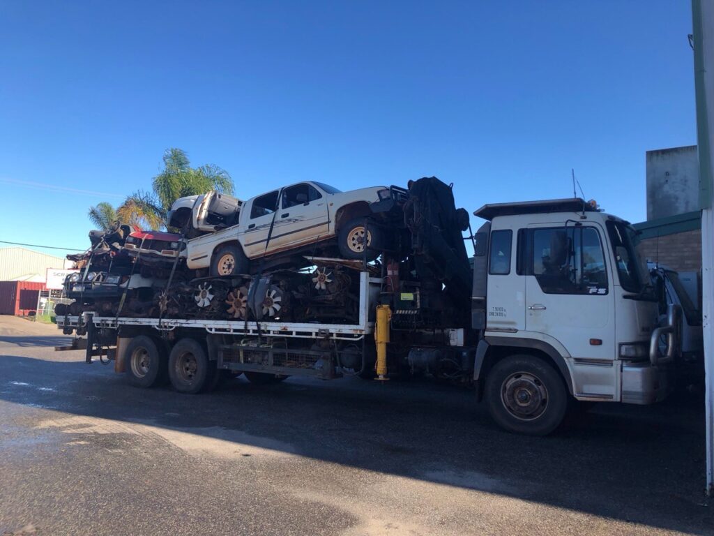Truck is towing old and junk cars